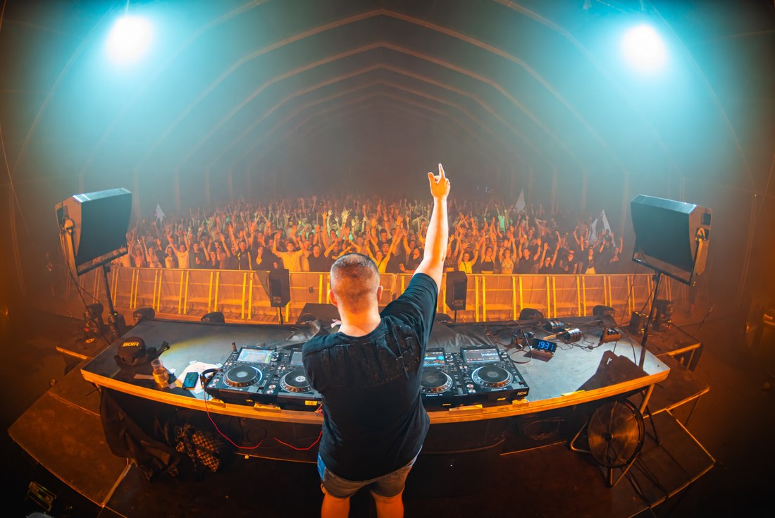 TiGi at the decks in front of a festival crowd