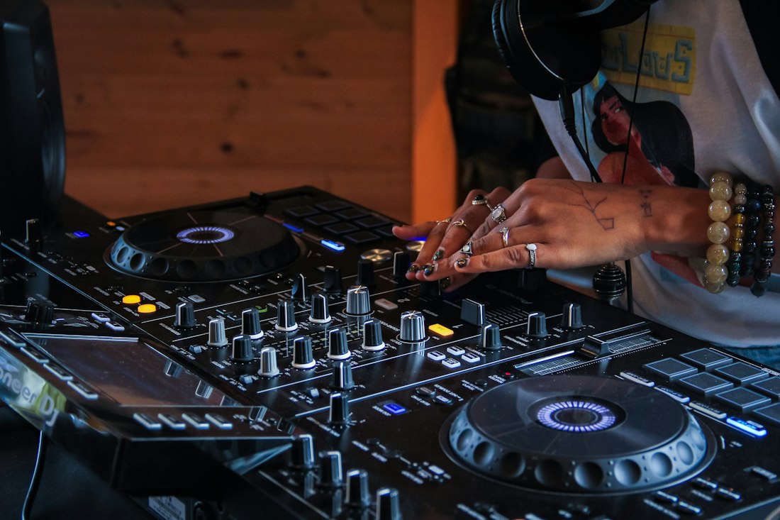 A DJ at the mixing desk preparing a set